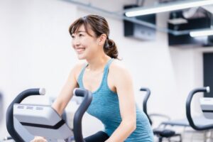 ジムでお腹の脂肪を落とすために有酸素運動をしている女性
